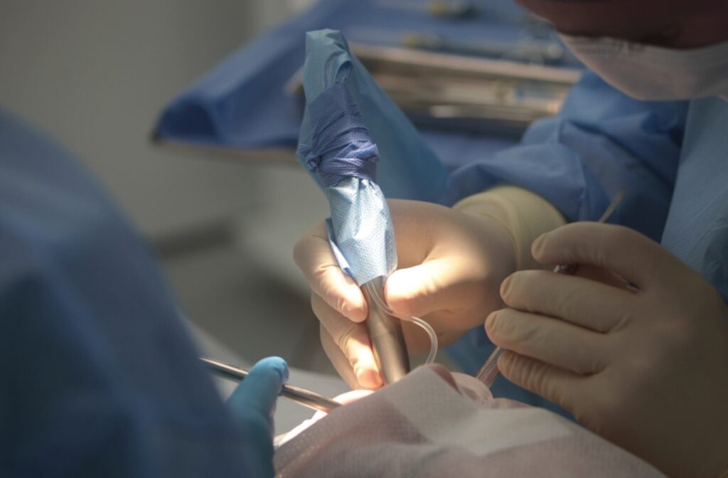 Dental surgeon operating on a patient.