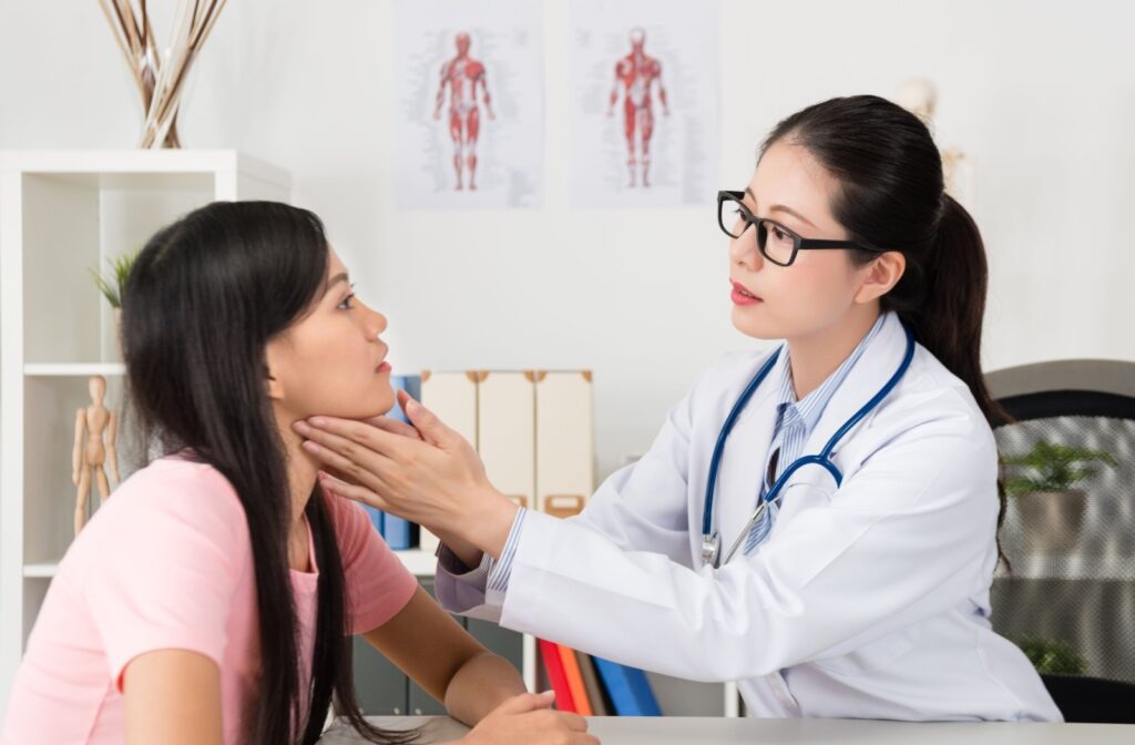 Oral and maxillofacial surgeon consulting with a patient about orthognathic (corrective jaw) surgery.